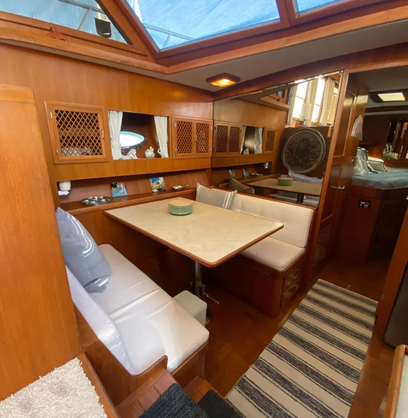 Slide: The Image of 1991 Lien Hwa McKinna 42 Aft Cabin interior with dining area and wooden cabinetry. - 44