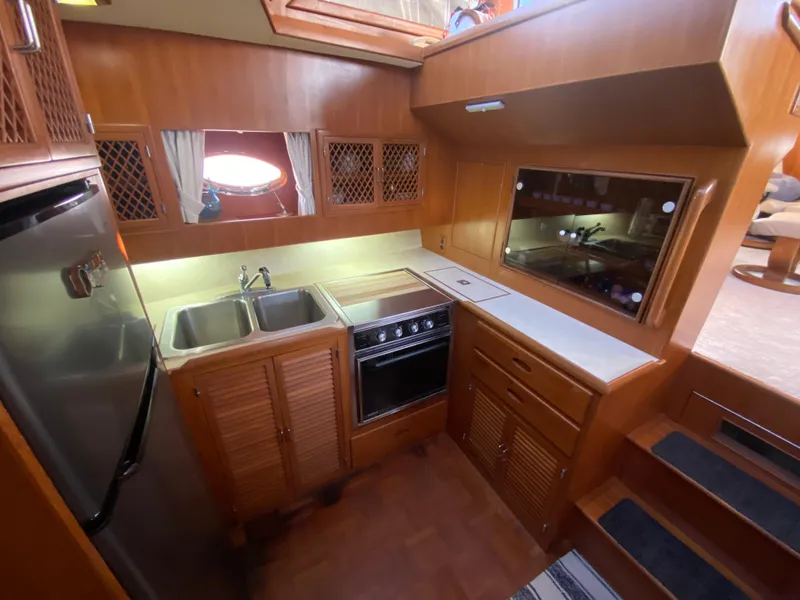 Slide: The Image of 1991 Lien Hwa McKinna 42 Aft Cabin kitchen with wood cabinetry and stainless steel appliances. - 46