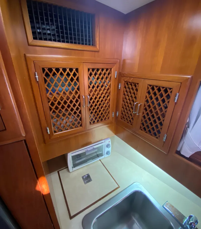 Slide: The Image of 1991 Lien Hwa McKinna 42 Aft Cabin kitchen with wooden cabinets and stainless steel sink. - 47