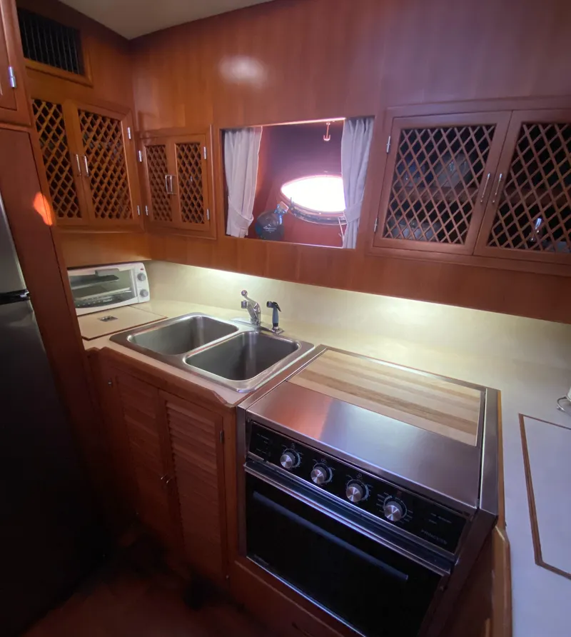 Slide: The Image of 1991 Lien Hwa McKinna 42 Aft Cabin kitchen with wood cabinets and stainless steel appliances. - 48