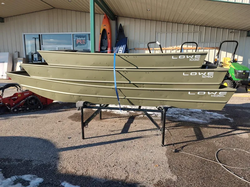 Slide: The Image of Stacked Lowe Jon L1240 boats, 2025 model, displayed outdoors on a stand. - 9