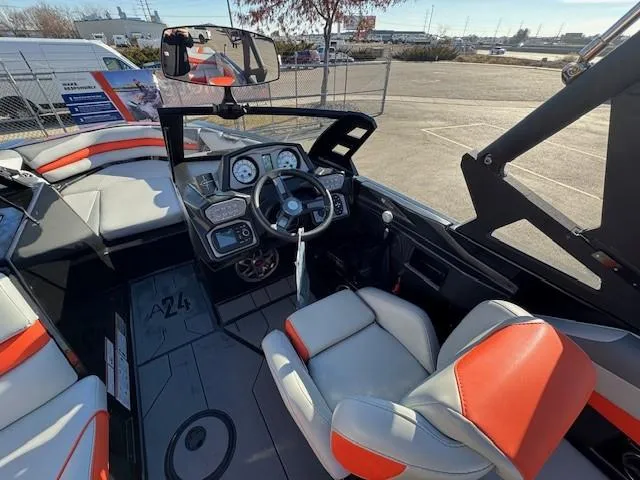 Slide: The Image of 2019 Axis A24 boat interior with steering wheel and seating, featuring modern dashboard controls. - 16