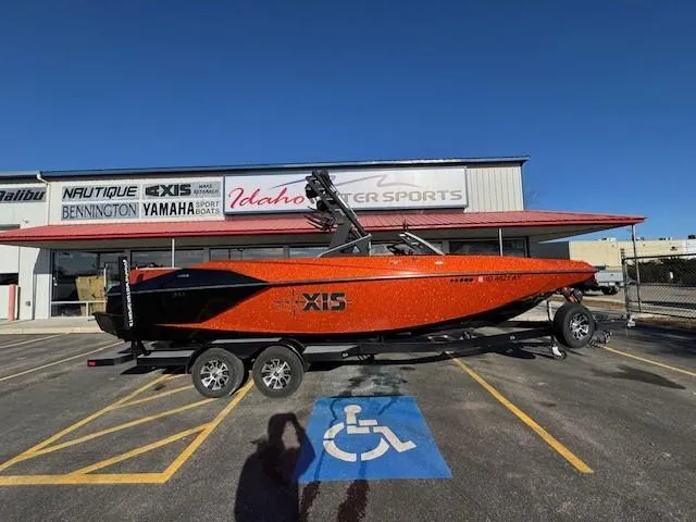 Slide: The Image of 2019 Axis A24 boat in orange, parked at Idaho Water Sports dealership. - 2