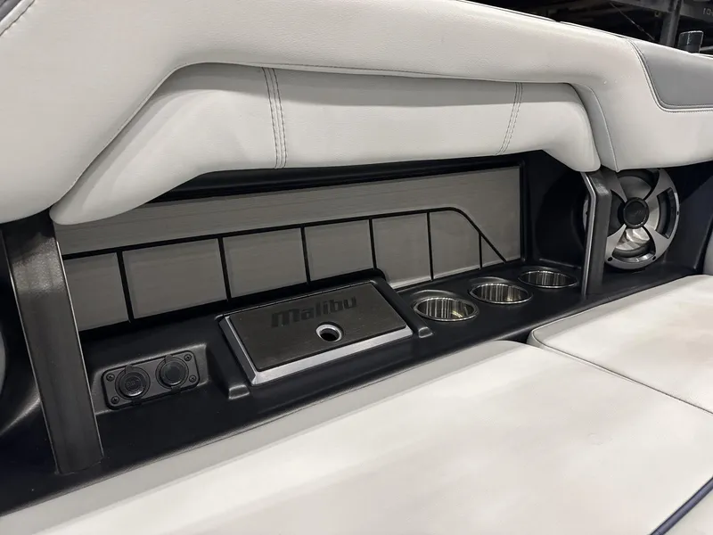 Slide: The Image of Interior of 2021 Malibu 25 LSV boat with cup holders and speaker. - 14