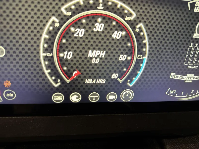 Slide: The Image of Dashboard of a 2021 Malibu 25 LSV boat showing speedometer and engine hours. - 16