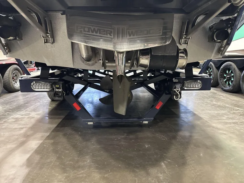 Slide: The Image of Rear view of 2021 Malibu 25 LSV boat with Power Wedge and propeller. - 4