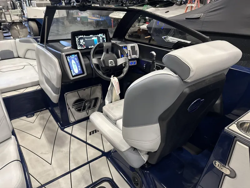 Slide: The Image of Interior of a 2021 Malibu 25 LSV boat with modern dashboard and seating. - 9