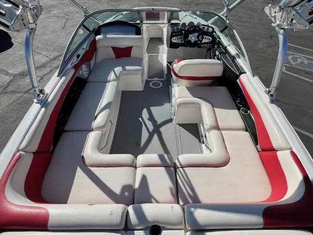 Slide: The Image of 2006 MasterCraft X45 boat interior with red and white seating, spacious layout, and modern dashboard. - 10