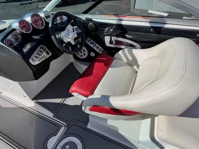 Slide: The Image of 2006 MasterCraft X45 boat interior with steering wheel and red-accented seat. - 12