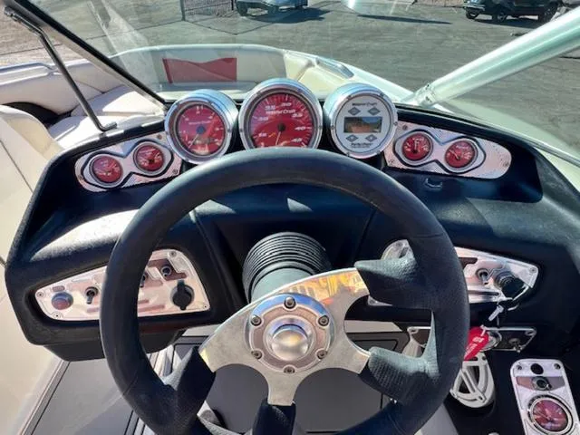 Slide: The Image of Dashboard of a 2006 MasterCraft X45 boat with gauges and steering wheel. - 18