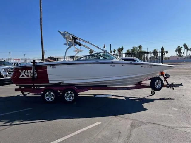 Slide: The Image of 2006 MasterCraft X45 boat on trailer in sunny parking lot. - 5