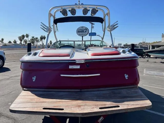 Slide: The Image of 2006 MasterCraft X45 boat with red exterior, rear view, parked on a trailer. - 7