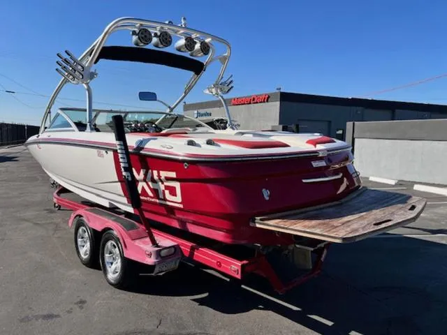 Slide: The Image of 2006 MasterCraft X45 boat on trailer, red and white, parked outdoors. - 8