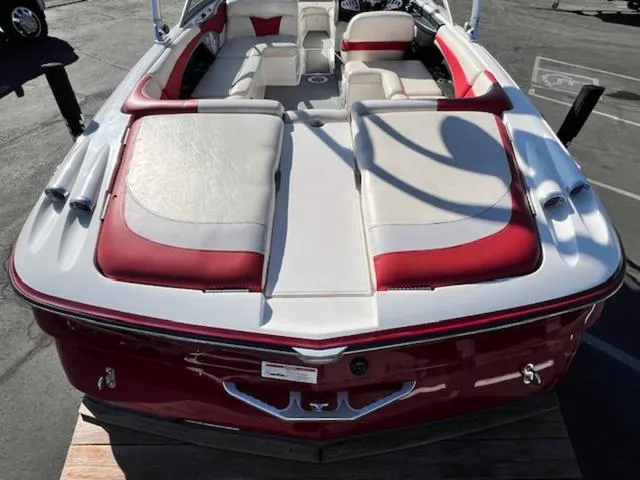 Slide: The Image of 2006 MasterCraft X45 boat with red and white interior, docked on a sunny day. - 9