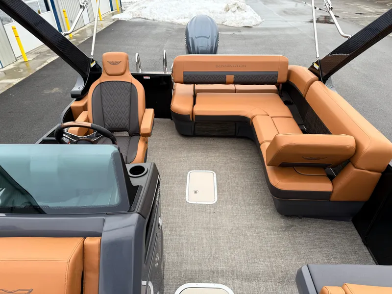 Slide: The Image of 2025 Bennington 24MSB boat interior with tan leather seating and modern design. - 14