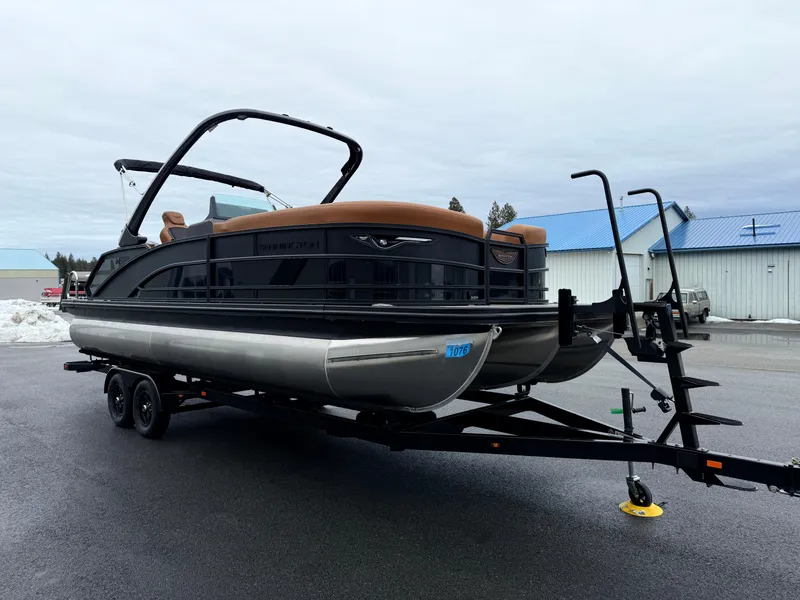 Slide: The Image of 2025 Bennington 24MSB pontoon boat on trailer, parked outdoors. - 3
