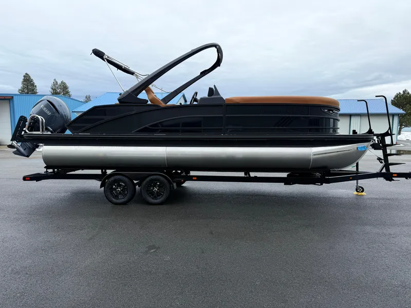 Slide: The Image of 2025 Bennington 24MSB pontoon boat on trailer, featuring sleek design and Yamaha outboard motor. - 4