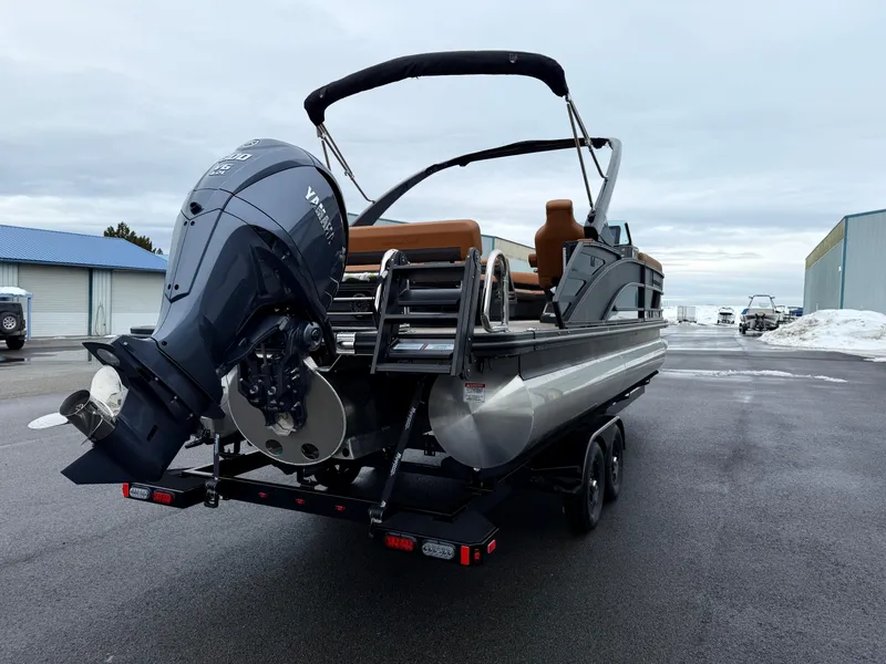 Slide: The Image of 2025 Bennington 24MSB pontoon boat with Yamaha outboard motor on trailer. - 5