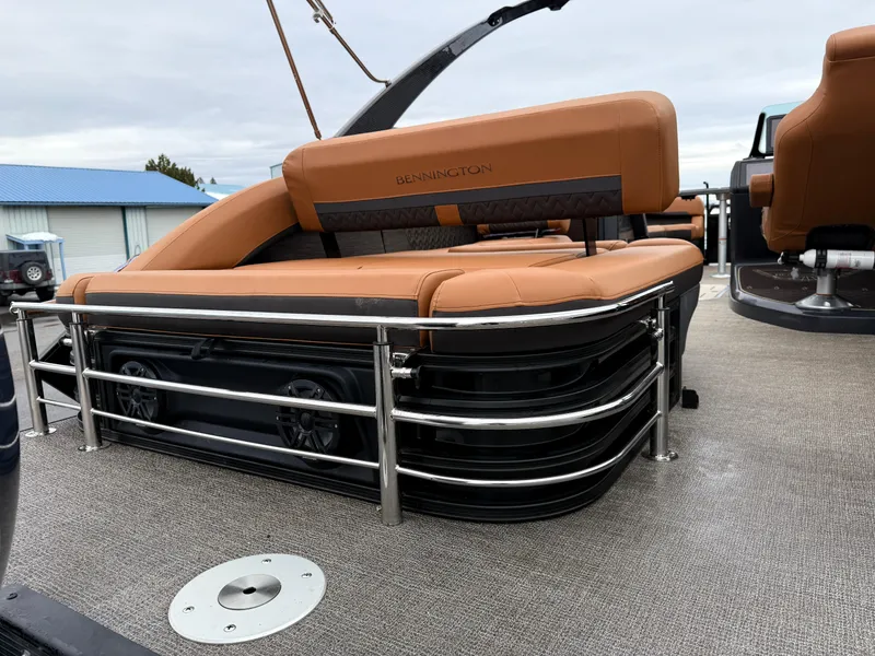 Slide: The Image of 2025 Bennington 24MSB boat interior with tan seating and metal railings. - 8