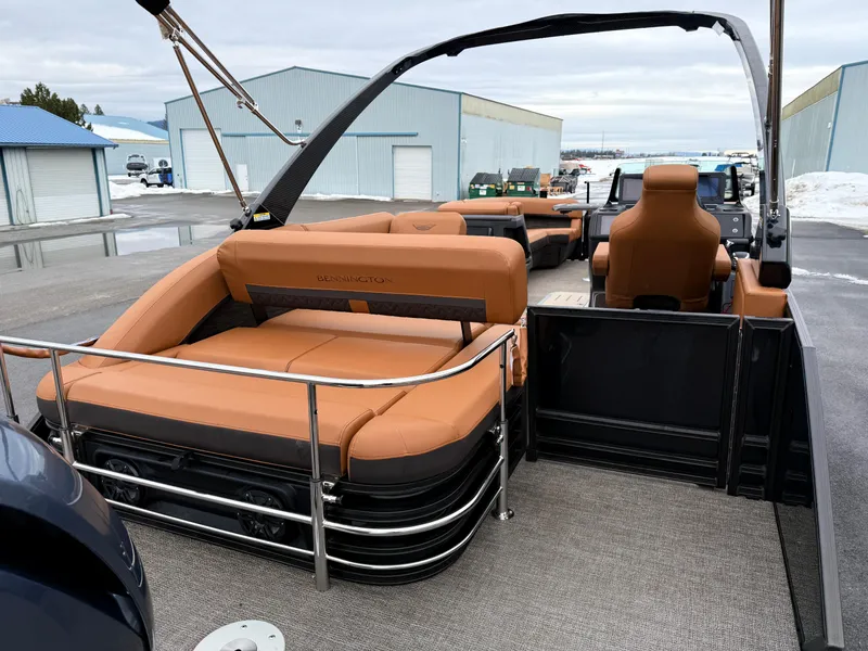 Slide: The Image of 2025 Bennington 24MSB pontoon boat with tan seating and sleek design. - 9