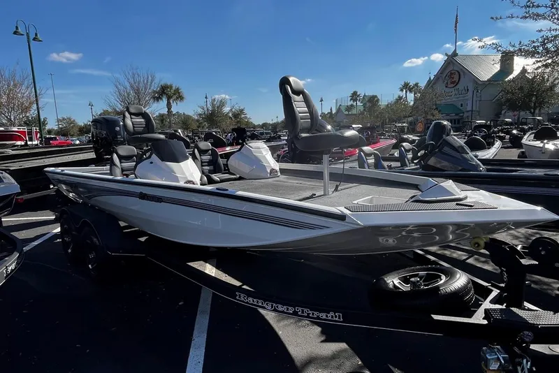 The Image of 2025 Ranger RT188P boat displayed outdoors on a trailer under a clear blue sky. - 0