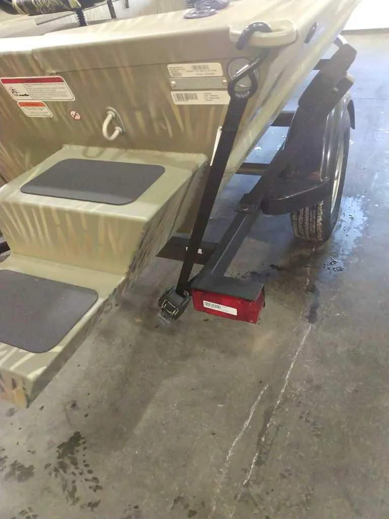 Slide: The Image of 2025 Tracker Grizzly 1654 T Sportsman boat on trailer in garage setting. - 38
