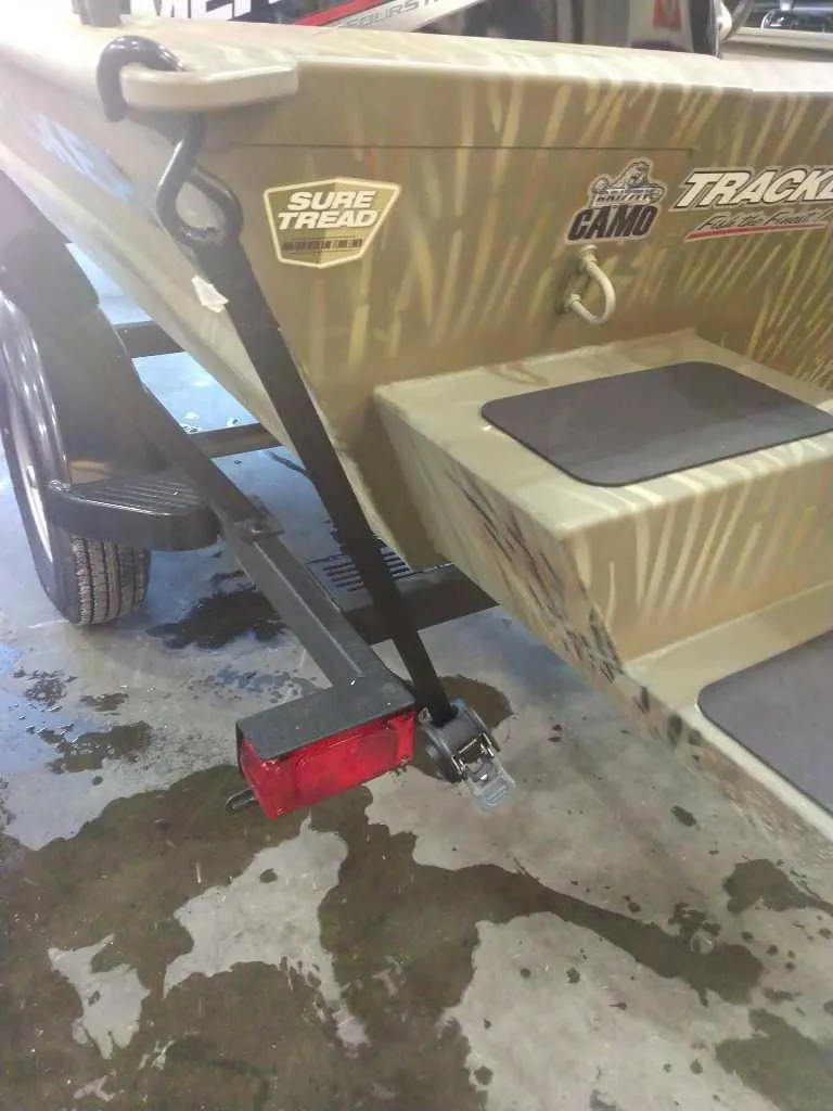 Slide: The Image of 2025 Tracker Grizzly 1654 T Sportsman boat on trailer, featuring Sure Tread design. - 39