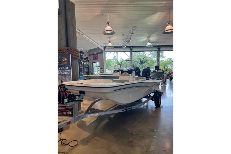 The Image of 2025 Mako Pro Skiff 15 CC displayed in a showroom with modern lighting. - 0