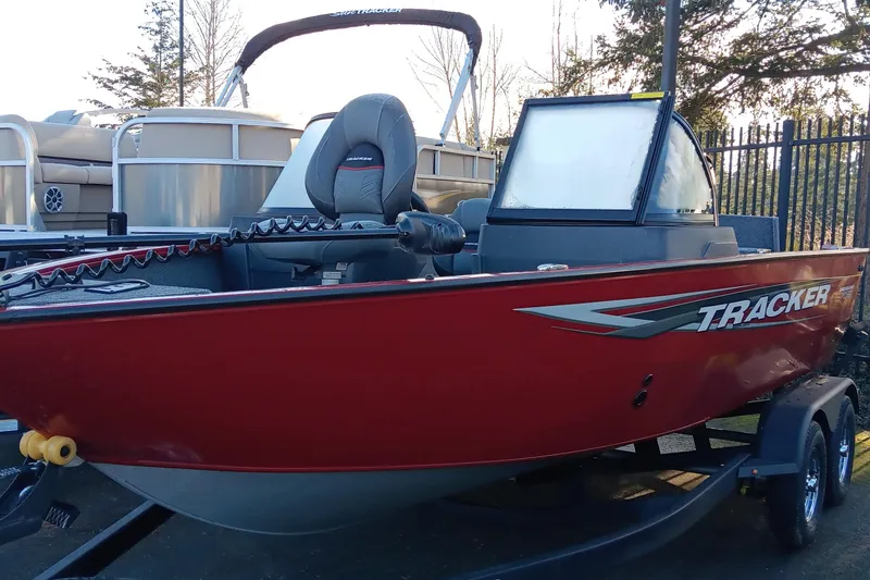 The Image of 2025 Tracker Pro Guide V-175 Combo boat, red exterior, parked on trailer. - 0