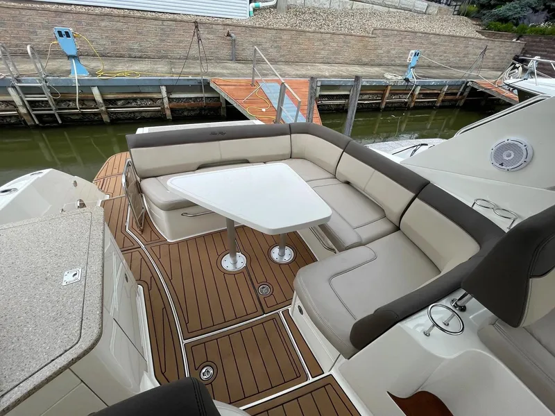 Slide: The Image of 2015 Sea Ray 350 Sundancer boat with elegant seating and table on deck. - 1