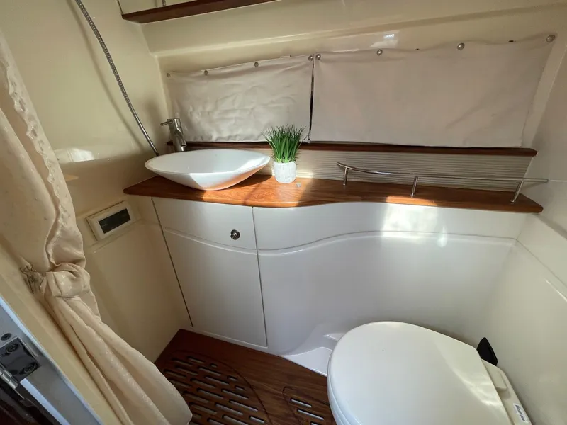Slide: The Image of Bathroom interior of 2015 Sea Ray 350 Sundancer yacht with modern sink and toilet. - 10