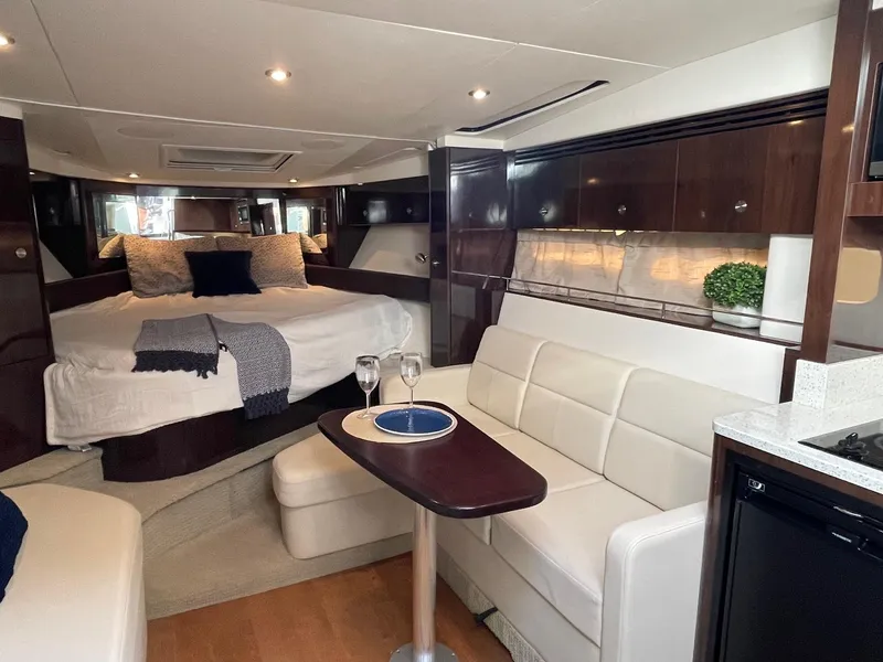 Slide: The Image of Interior of 2015 Sea Ray 350 Sundancer yacht with elegant seating and cozy bed. - 11