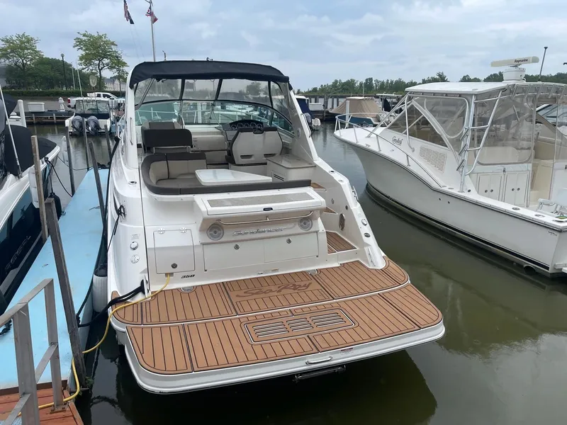 Slide: The Image of 2015 Sea Ray 350 Sundancer docked, featuring spacious deck and seating area. - 5