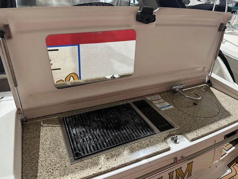 Slide: The Image of Outdoor kitchen area on a 2015 Sea Ray 350 Sundancer boat. - 6
