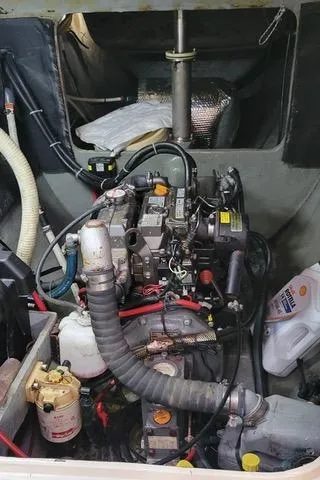 Slide: The Image of Engine compartment of a 2001 Voyage Maxim boat, showing mechanical components and hoses. - 13