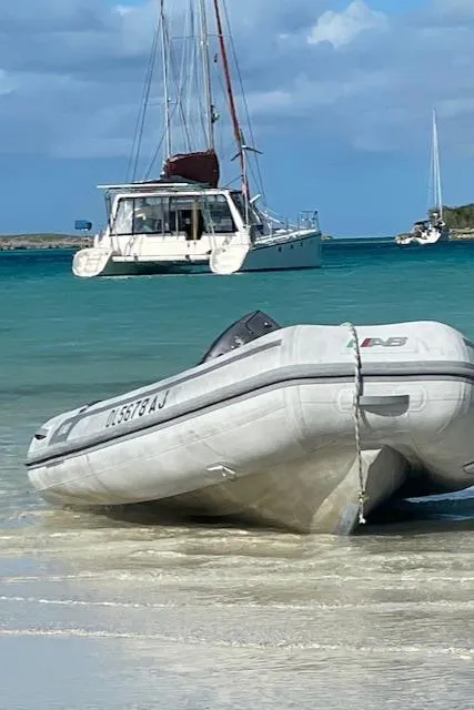 Slide: The Image of Inflatable boat on sandy beach with sailboats in turquoise water; Voyage Maxim 2001. - 17