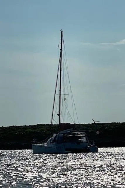 Slide: The Image of Sailboat on shimmering water, Voyage Maxim 2001, silhouetted against the sky. - 18