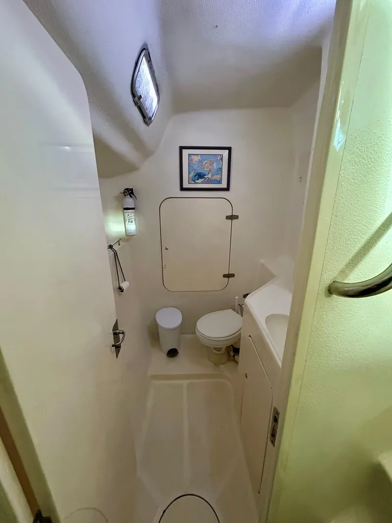 Slide: The Image of Compact bathroom in 2001 Voyage Maxim boat with toilet, sink, and wall art. - 22
