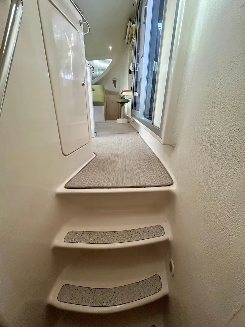 Slide: The Image of Interior of 2001 Voyage Maxim yacht, featuring carpeted steps and modern design. - 26