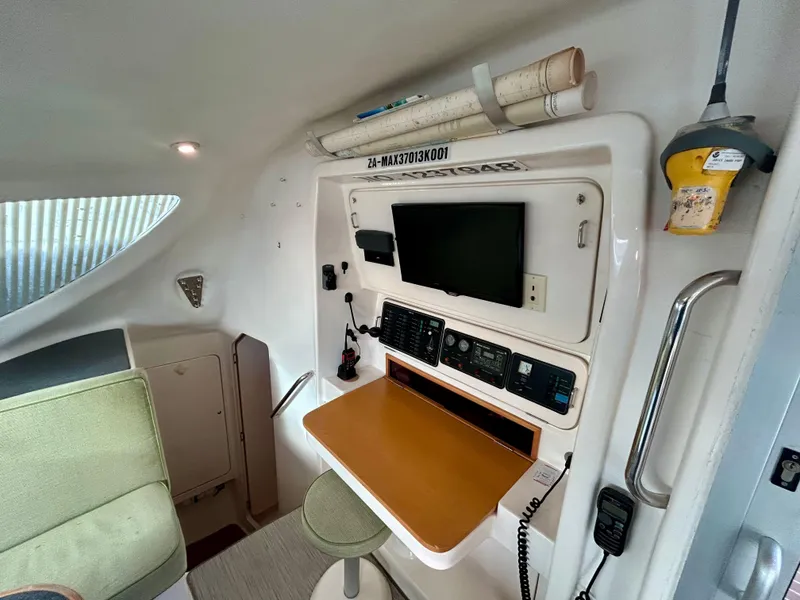Slide: The Image of Navigation station inside 2001 Voyage Maxim yacht with communication equipment and seating. - 35