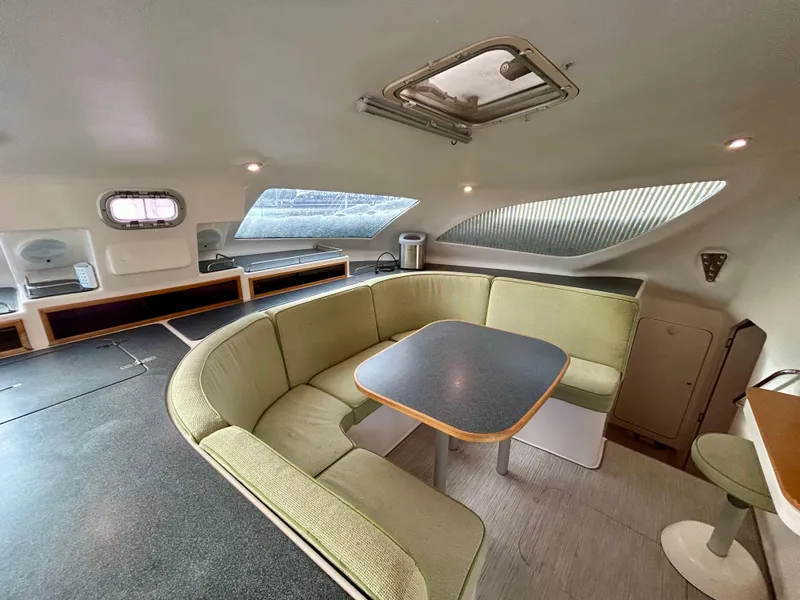 Slide: The Image of Interior of 2001 Voyage Maxim yacht with green seating and modern table. - 38