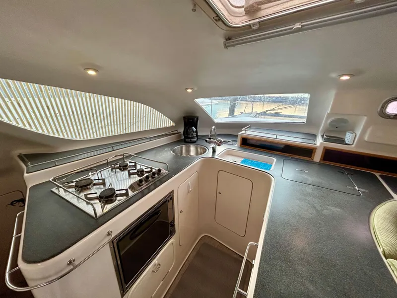 Slide: The Image of Modern kitchen interior of 2001 Voyage Maxim yacht with stove, sink, and seating area. - 39