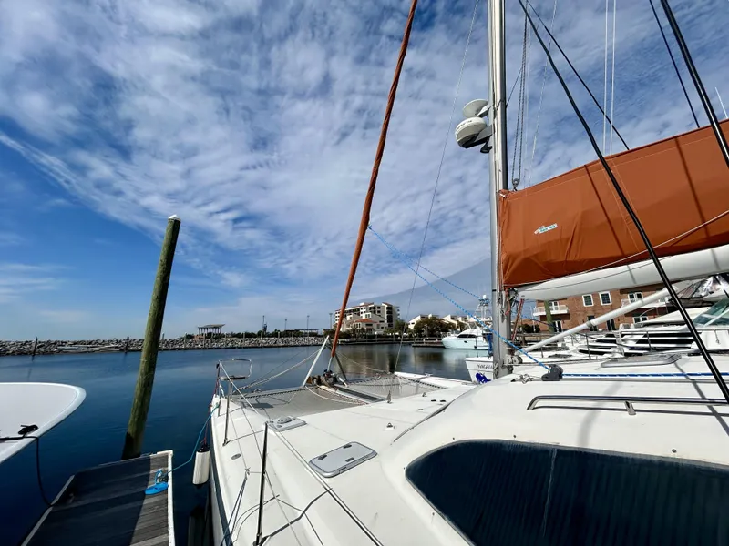 Slide: The Image of Sailboat docked at marina under blue sky, Voyage Maxim 2001 model. - 42