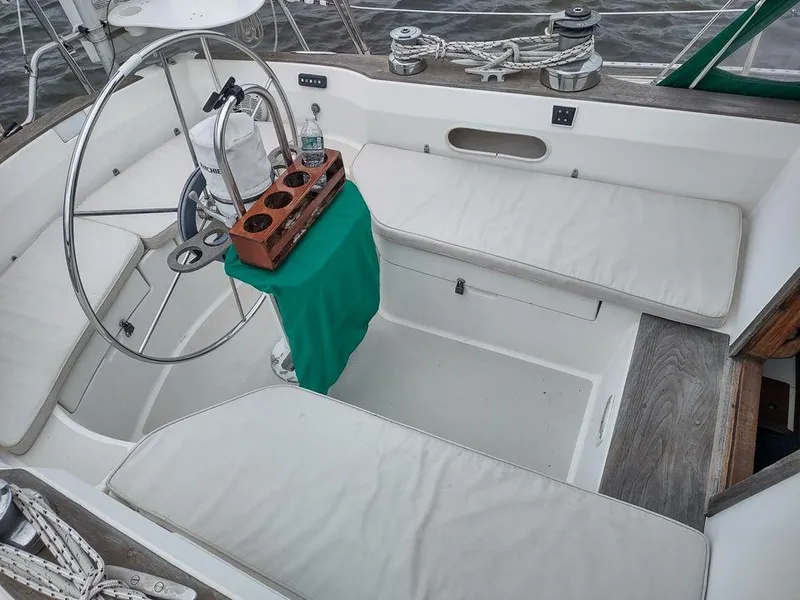 Slide: The Image of Cockpit of 1983 Sabre 38 sailboat with wheel, seating, and cup holder. - 11