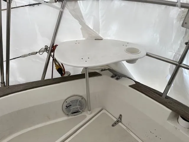 Slide: The Image of Cockpit area of a 1983 Sabre 38 sailboat with a small table and speaker. - 19