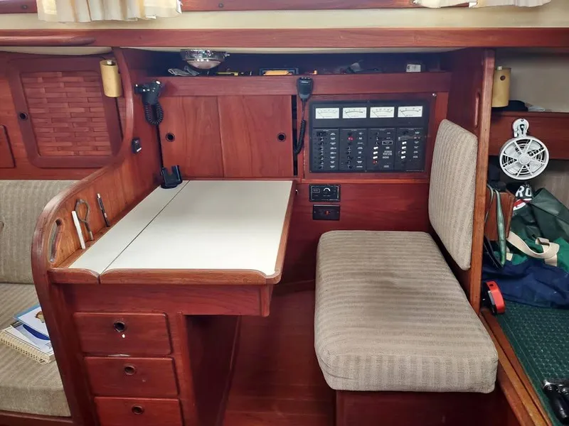 Slide: The Image of Navigation station in a 1983 Sabre 38 sailboat with control panels and seating. - 8