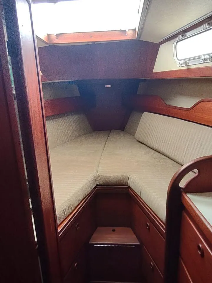 Slide: The Image of 1983 Sabre 38 sailboat interior with wooden finish and cushioned seating. - 9