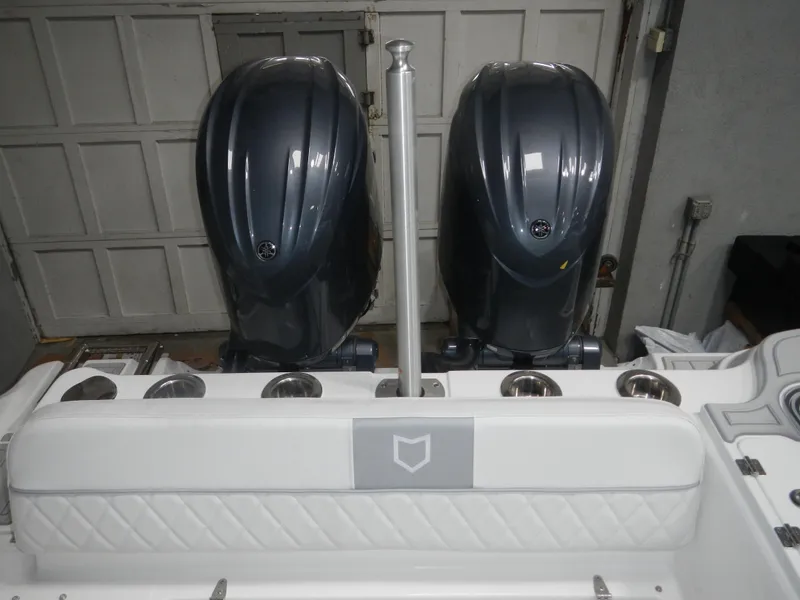 Slide: The Image of 2025 Sea Fox 268 Traveler with dual outboard engines in a garage setting. - 11