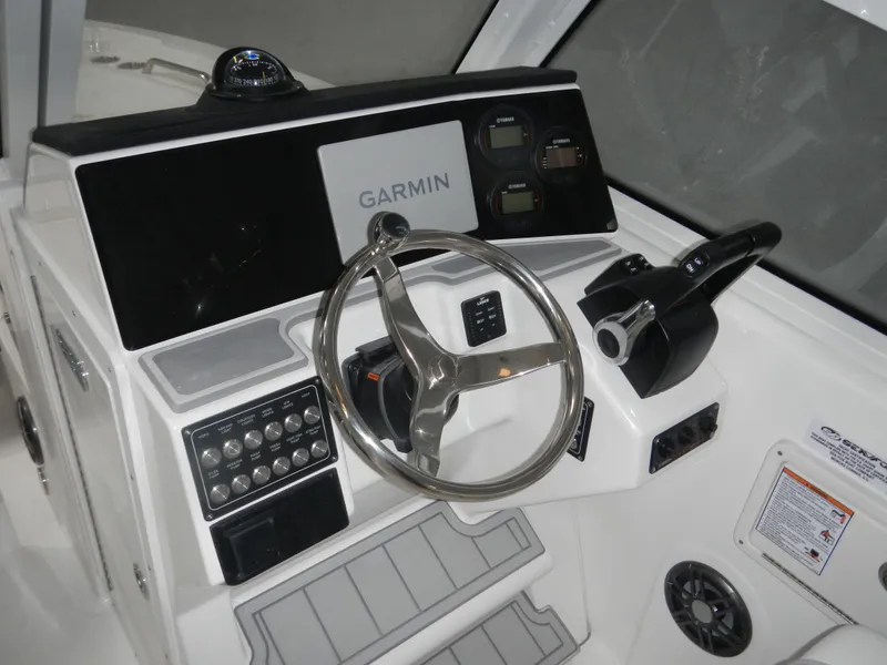 Slide: The Image of 2025 Sea Fox 268 Traveler boat dashboard with Garmin navigation system and steering wheel. - 12