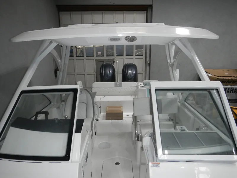 Slide: The Image of 2025 Sea Fox 268 Traveler boat with dual engines in a garage setting. - 2